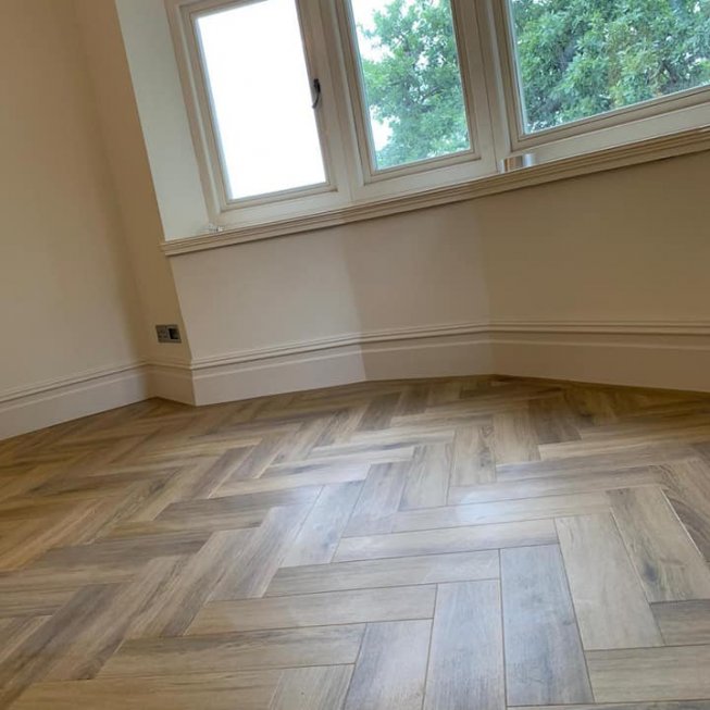 Amtico Signature York Oak in a Large Herringbone Design with a Board on Edge Border